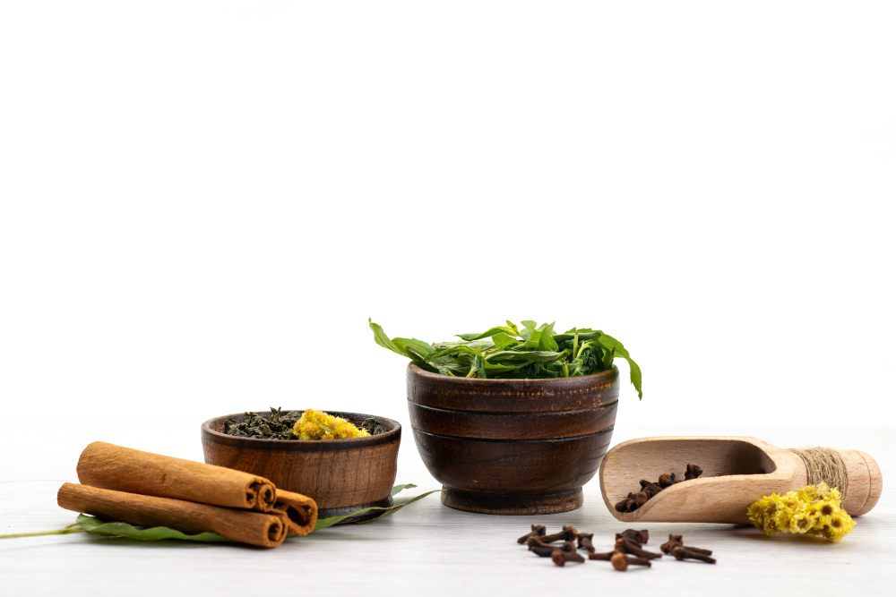 front view of cinnamon and basil leaves in bowl