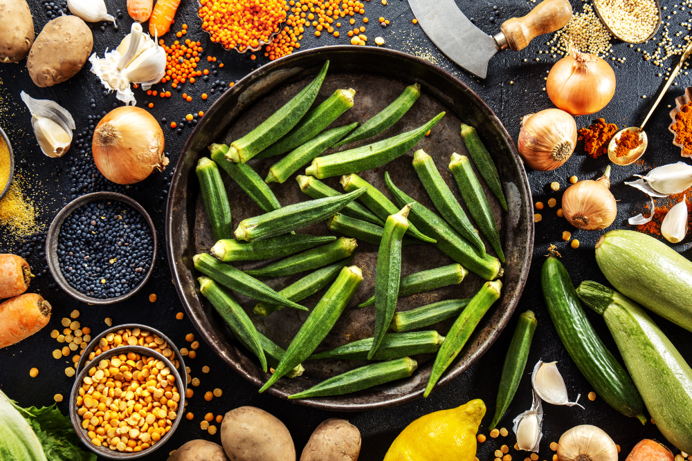 Variety of fresh vegetables including eggplant and okra